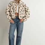 ivory floral sherpa jacket with rust and green print, contrast brown piping, snap front, stand collar, and relaxed fit