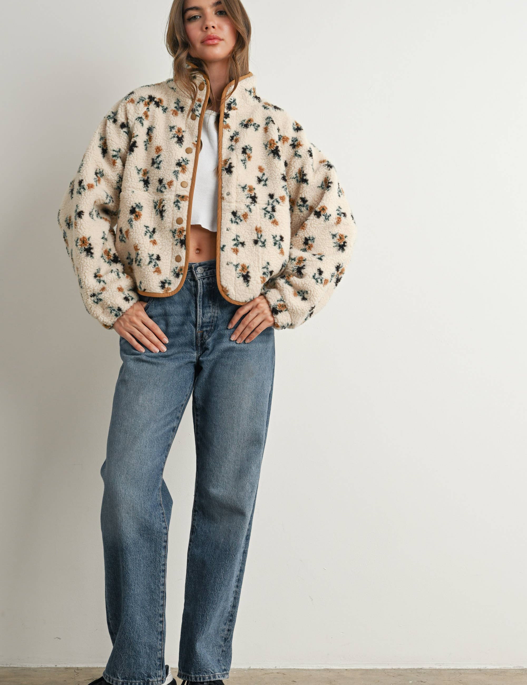 ivory floral sherpa jacket with rust and green print, contrast brown piping, snap front, stand collar, and relaxed fit