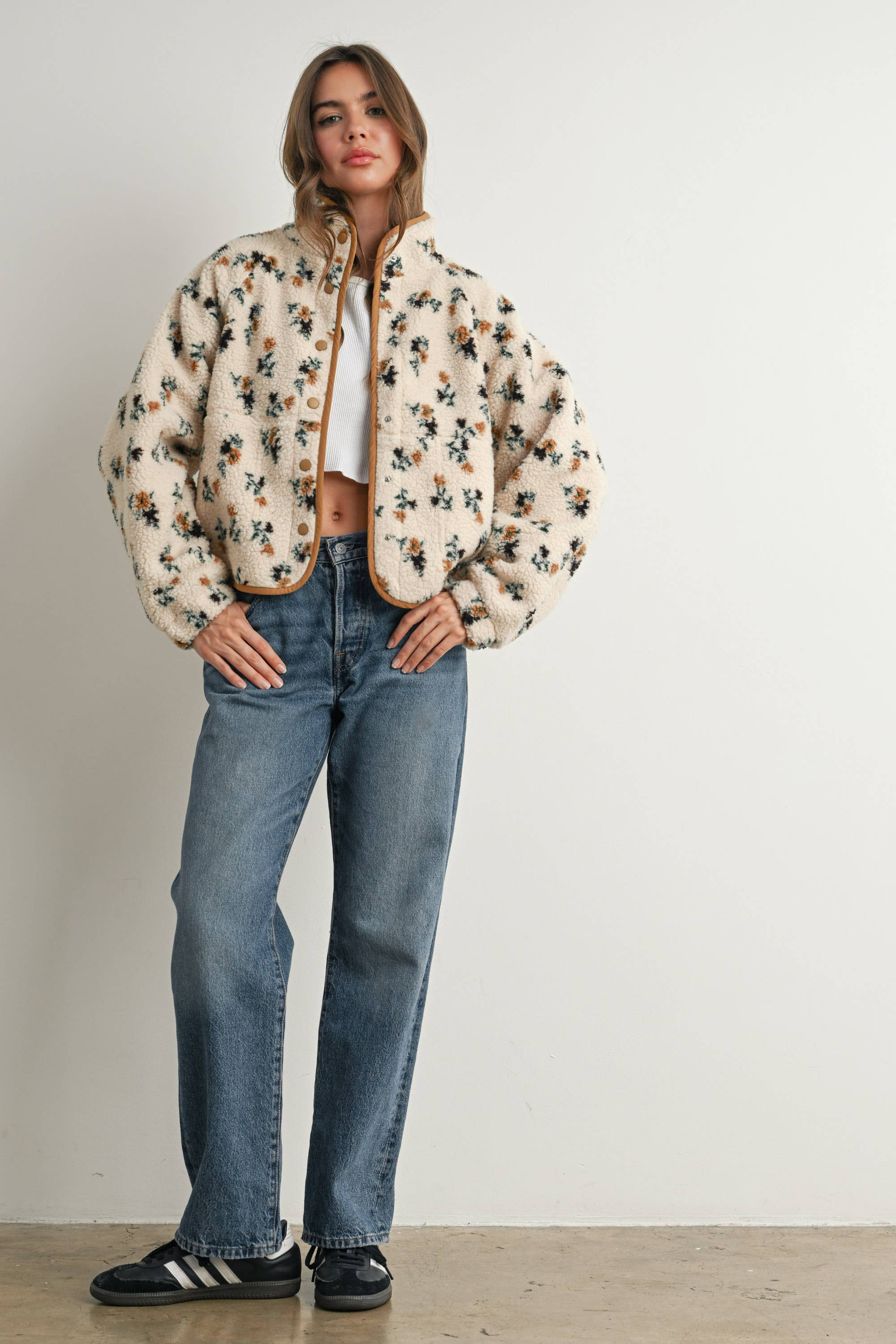 ivory floral sherpa jacket with rust and green print, contrast brown piping, snap front, stand collar, and relaxed fit