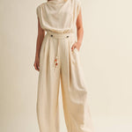 cream wide leg jumpsuit, cowl neck jumpsuit, linen blend jumpsuit, neutral one piece outfit, drawstring waist jumpsuit, resort wear jumpsuit, cap sleeve jumpsuit, flowy wide leg romper, elegant casual jumpsuit, women's cream jumpsuit