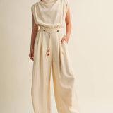 cream wide leg jumpsuit, cowl neck jumpsuit, linen blend jumpsuit, neutral one piece outfit, drawstring waist jumpsuit, resort wear jumpsuit, cap sleeve jumpsuit, flowy wide leg romper, elegant casual jumpsuit, women's cream jumpsuit