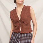 rust brown sleeveless embroidered blouse with v-neck tie, pintuck details, ruffled trim and button front
