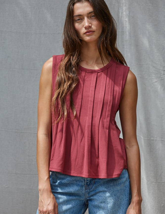 rust red sleeveless rayon blend tank top with front pleats, crew neckline and relaxed gathered silhouette