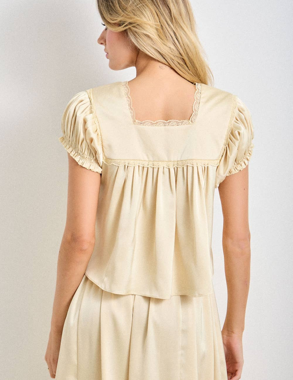 a chocolate satin top with lace trim, a deep v-neckline and flowy empire silhouette. available small–3x with matching Alpenrose pants sold separately.