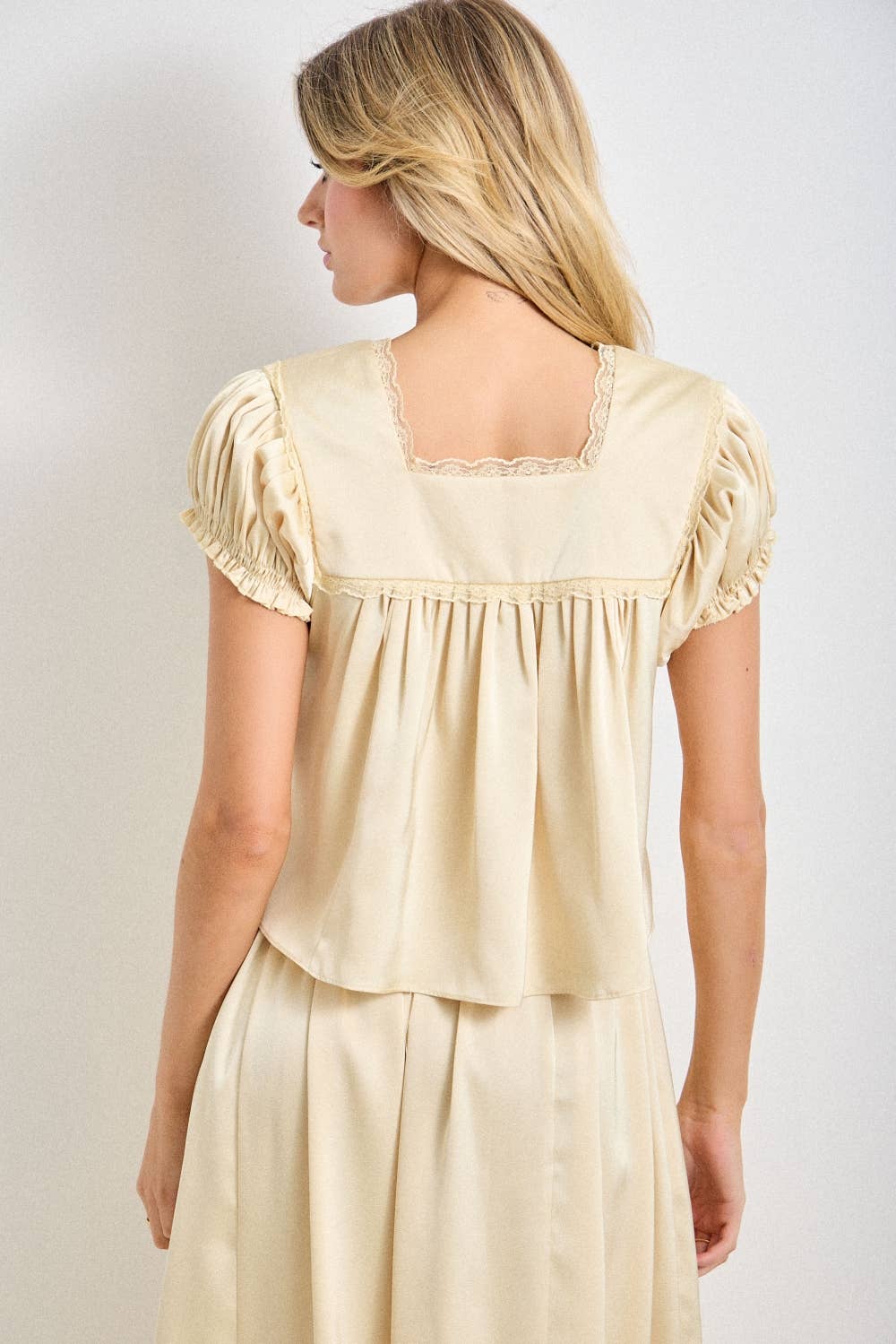 a chocolate satin top with lace trim, a deep v-neckline and flowy empire silhouette. available small–3x with matching Alpenrose pants sold separately.
