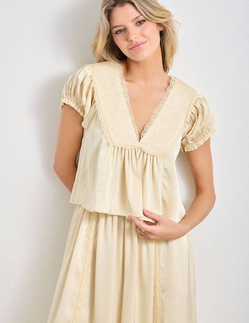 a chocolate satin top with lace trim, a deep v-neckline and flowy empire silhouette. available small–3x with matching Alpenrose pants sold separately.