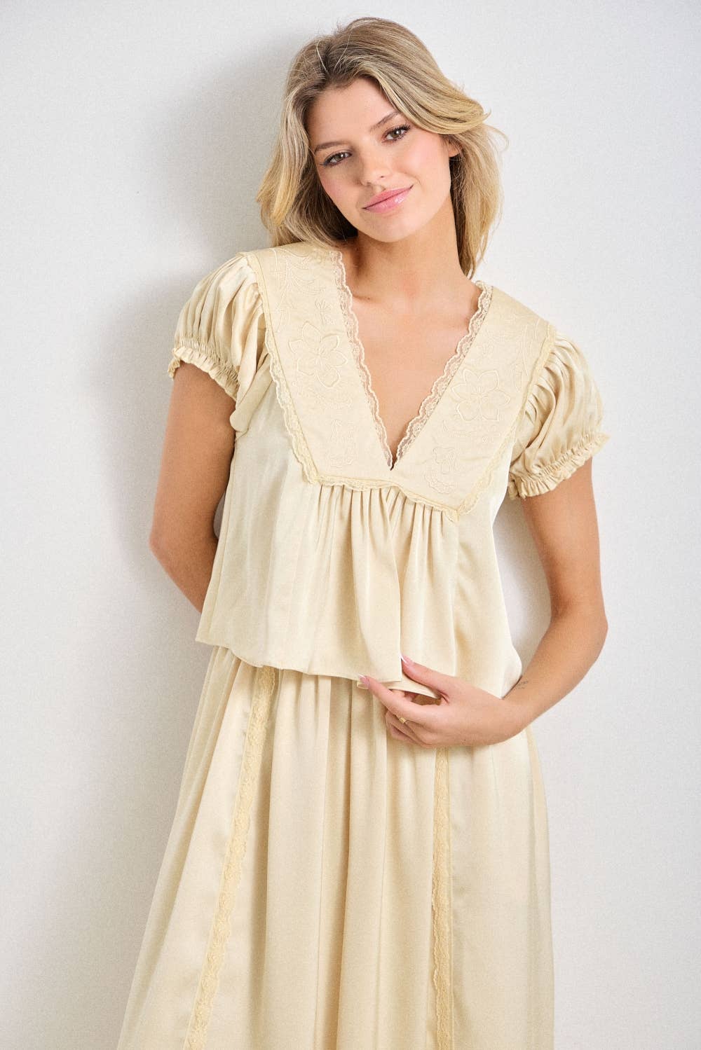 a chocolate satin top with lace trim, a deep v-neckline and flowy empire silhouette. available small–3x with matching Alpenrose pants sold separately.