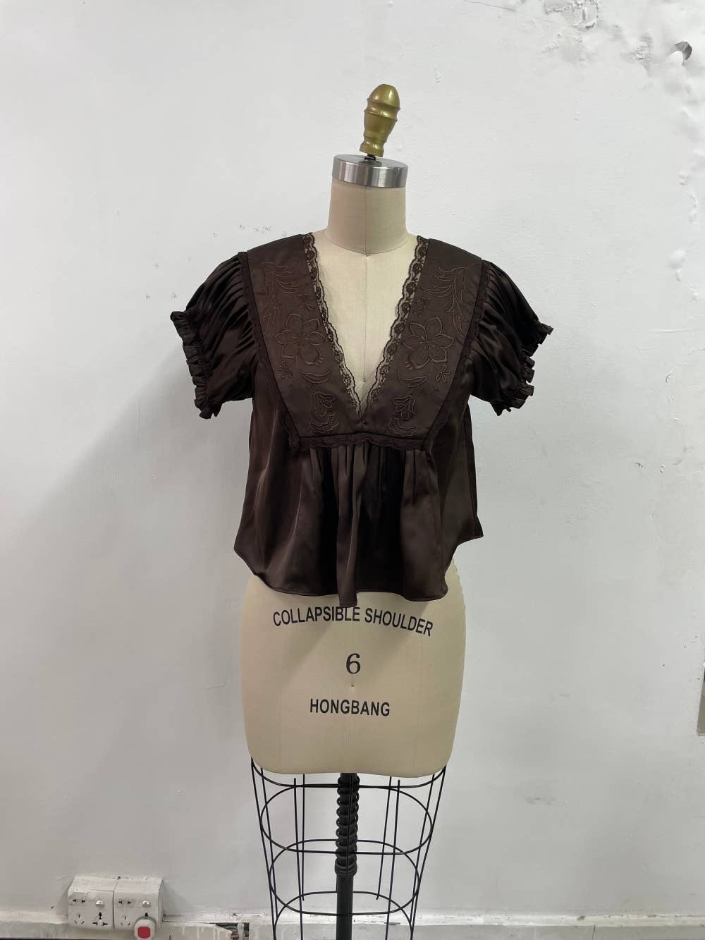 chocolate brown satin v-neck top with lace trim, empire waist and short flutter sleeves