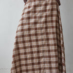 a brown and cream plaid midi skirt with a full flared silhouette and elastic back waistband. wear it alone or pair with the matching Antelope Top.