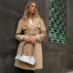 small silver structured shoulder bag shown on model