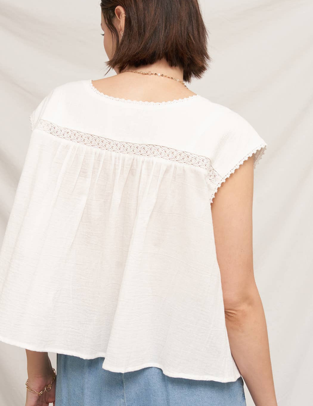 white embroidered blouse
embroidered summer top
white peasant blouse
lightweight rayon blouse
feminine summer top
casual white boutique top
embroidered detail shirt
relaxed fit white blouse
summer farmers market outfit
southern summer style
easy vacation outfit
white top with embroidery
flowy summer blouse
countryside summer fashion
casual feminine clothing
breathable warm weather top
white short sleeve blouse
classic summer wardrobe staple
boutique women's clothing
effortless everyday style