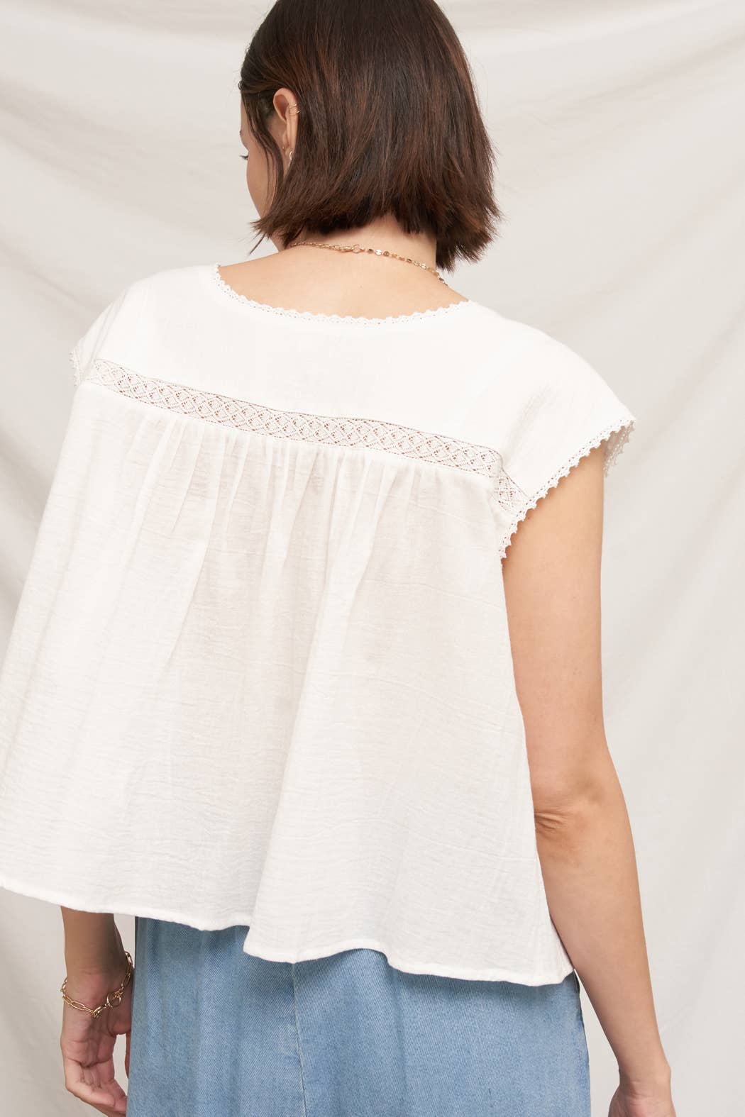white embroidered blouse
embroidered summer top
white peasant blouse
lightweight rayon blouse
feminine summer top
casual white boutique top
embroidered detail shirt
relaxed fit white blouse
summer farmers market outfit
southern summer style
easy vacation outfit
white top with embroidery
flowy summer blouse
countryside summer fashion
casual feminine clothing
breathable warm weather top
white short sleeve blouse
classic summer wardrobe staple
boutique women's clothing
effortless everyday style