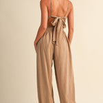 linen blend jumpsuit, tan jumpsuit women, bow back jumpsuit, smocked waist jumpsuit, square neck jumpsuit, relaxed fit one piece outfit, boho jumpsuit, wide leg jumpsuit, neutral summer jumpsuit, lightweight vacation outfit