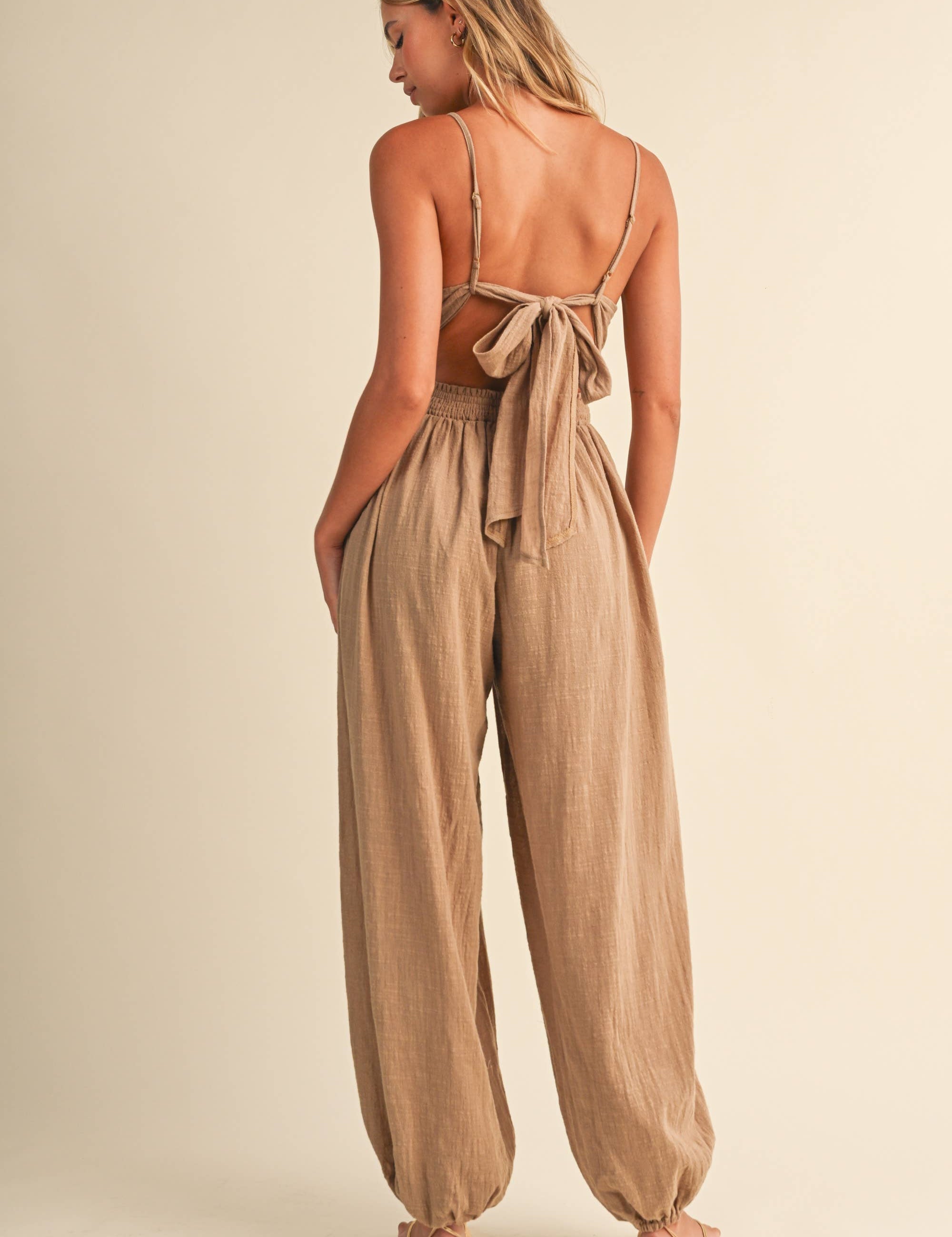 linen blend jumpsuit, tan jumpsuit women, bow back jumpsuit, smocked waist jumpsuit, square neck jumpsuit, relaxed fit one piece outfit, boho jumpsuit, wide leg jumpsuit, neutral summer jumpsuit, lightweight vacation outfit
