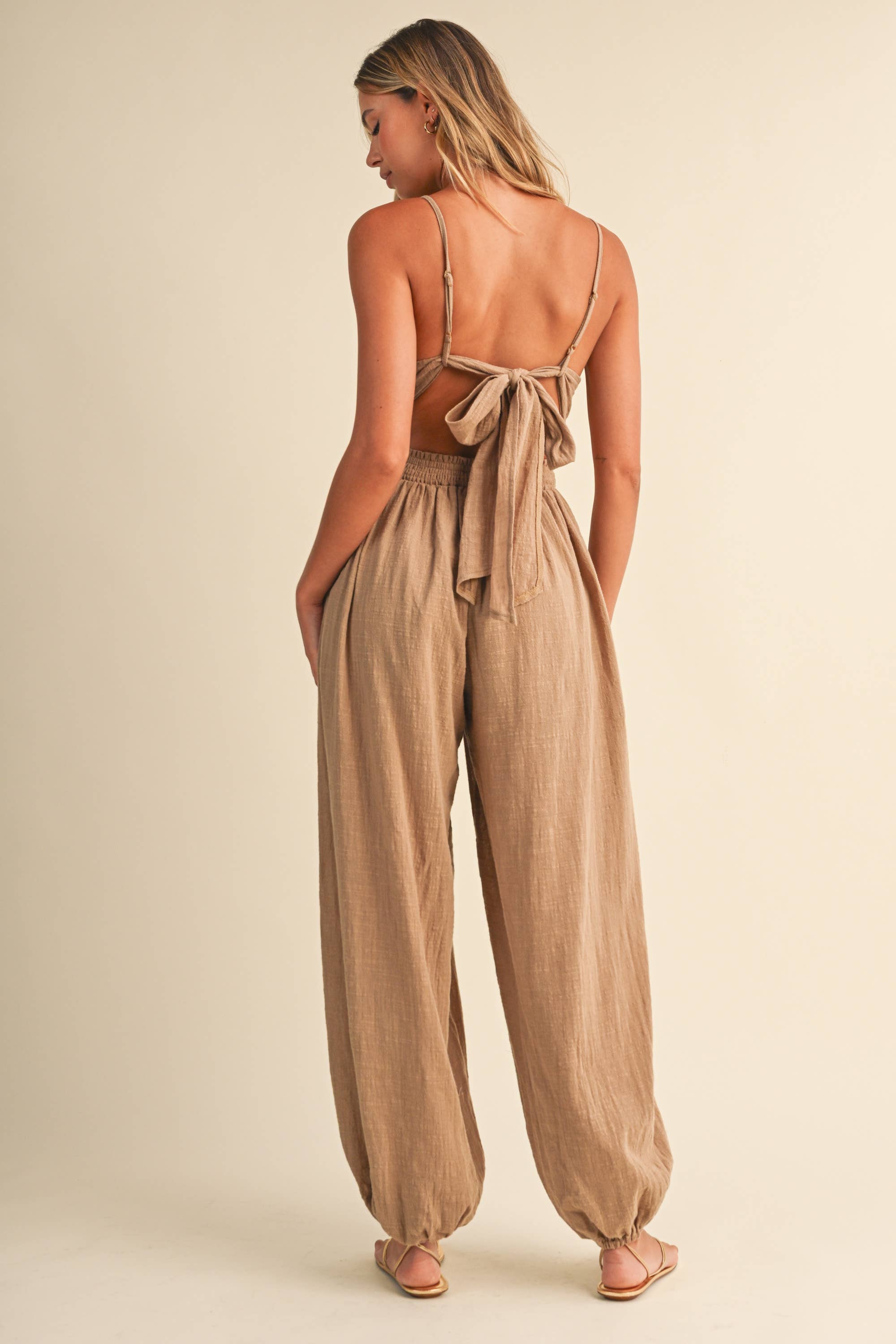 linen blend jumpsuit, tan jumpsuit women, bow back jumpsuit, smocked waist jumpsuit, square neck jumpsuit, relaxed fit one piece outfit, boho jumpsuit, wide leg jumpsuit, neutral summer jumpsuit, lightweight vacation outfit