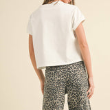 white boxy cotton t-shirt with relaxed fit
washed cotton crewneck tee with short sleeves
casual white cotton top styled with leopard pants
relaxed fit everyday cotton t-shirt
medium weight boxy cotton tee for women
classic white crewneck t-shirt with hip-length fit
minimalist cotton summer top
casual cotton tee for everyday wear