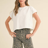 white boxy cotton t-shirt with relaxed fit
washed cotton crewneck tee with short sleeves
casual white cotton top styled with leopard pants
relaxed fit everyday cotton t-shirt
medium weight boxy cotton tee for women
classic white crewneck t-shirt with hip-length fit
minimalist cotton summer top
casual cotton tee for everyday wear