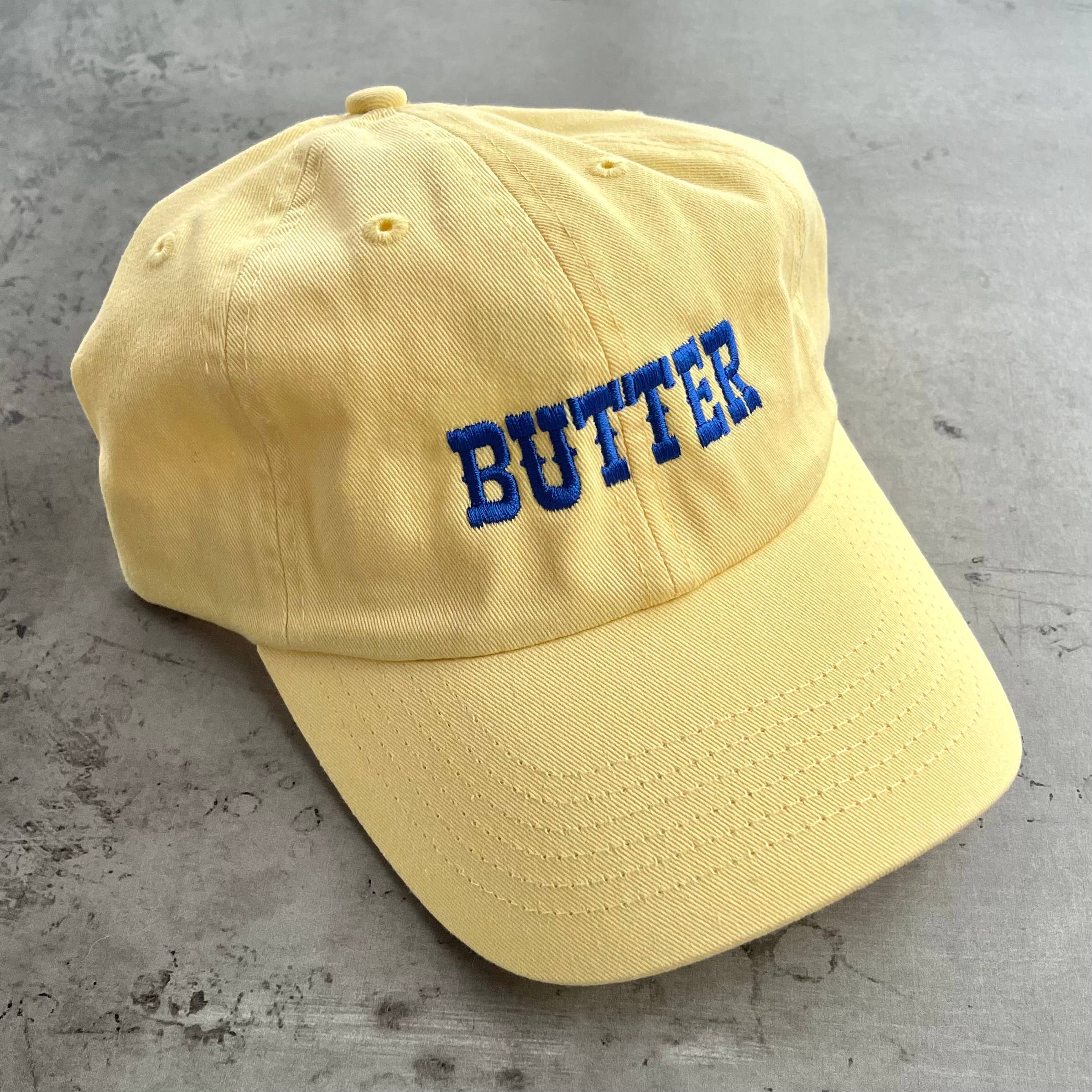 butter hat
butter baseball cap
yellow dad hat
embroidered baseball cap
funny food hat
americana baseball cap
butter yellow hat
embroidered cotton cap
novelty baseball hat
southern summer style
casual weekend hat
food lover gift
retro baseball cap
county fair outfit
quirky gift idea
adjustable dad hat
yellow cotton baseball cap
trendy embroidered hat
farmers market outfit
summer baseball cap