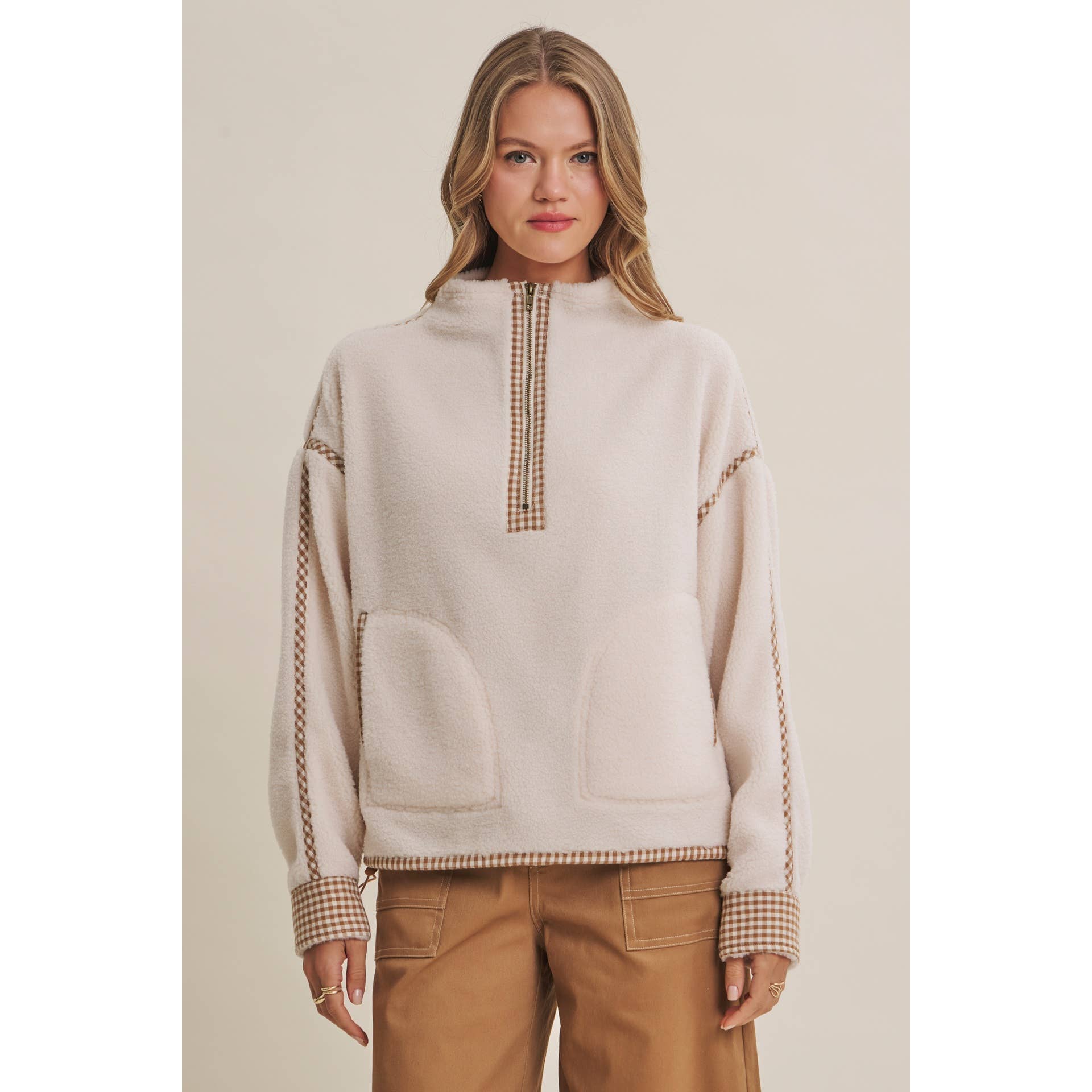 ivory sherpa fleece half zip pullover with brown gingham trim, front patch pockets, and adjustable drawcord hem