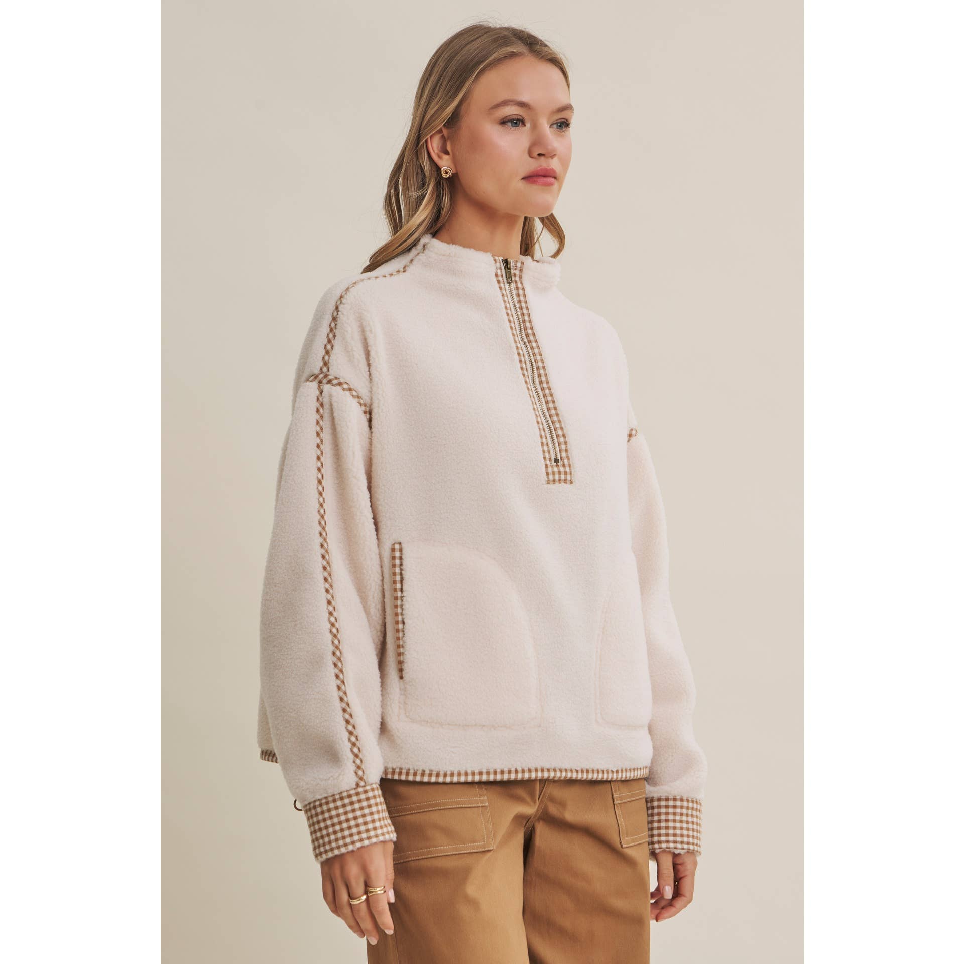 ivory sherpa fleece half zip pullover with brown gingham trim, front patch pockets, and adjustable drawcord hem