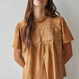 women's butterscotch brown short sleeve top with suede-like finish, ruffle neckline, lace chest detail, and relaxed fit