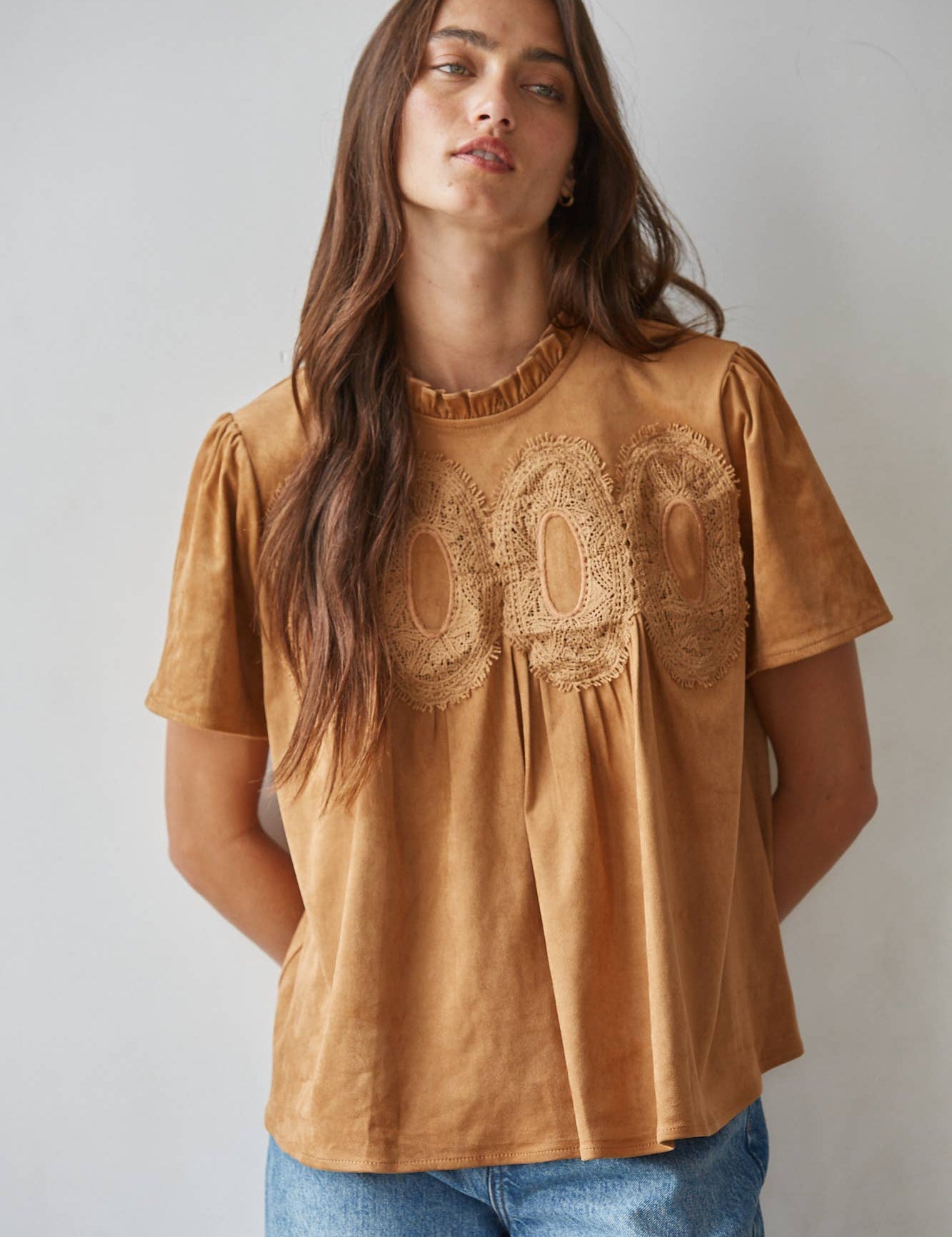 women's butterscotch brown short sleeve top with suede-like finish, ruffle neckline, lace chest detail, and relaxed fit