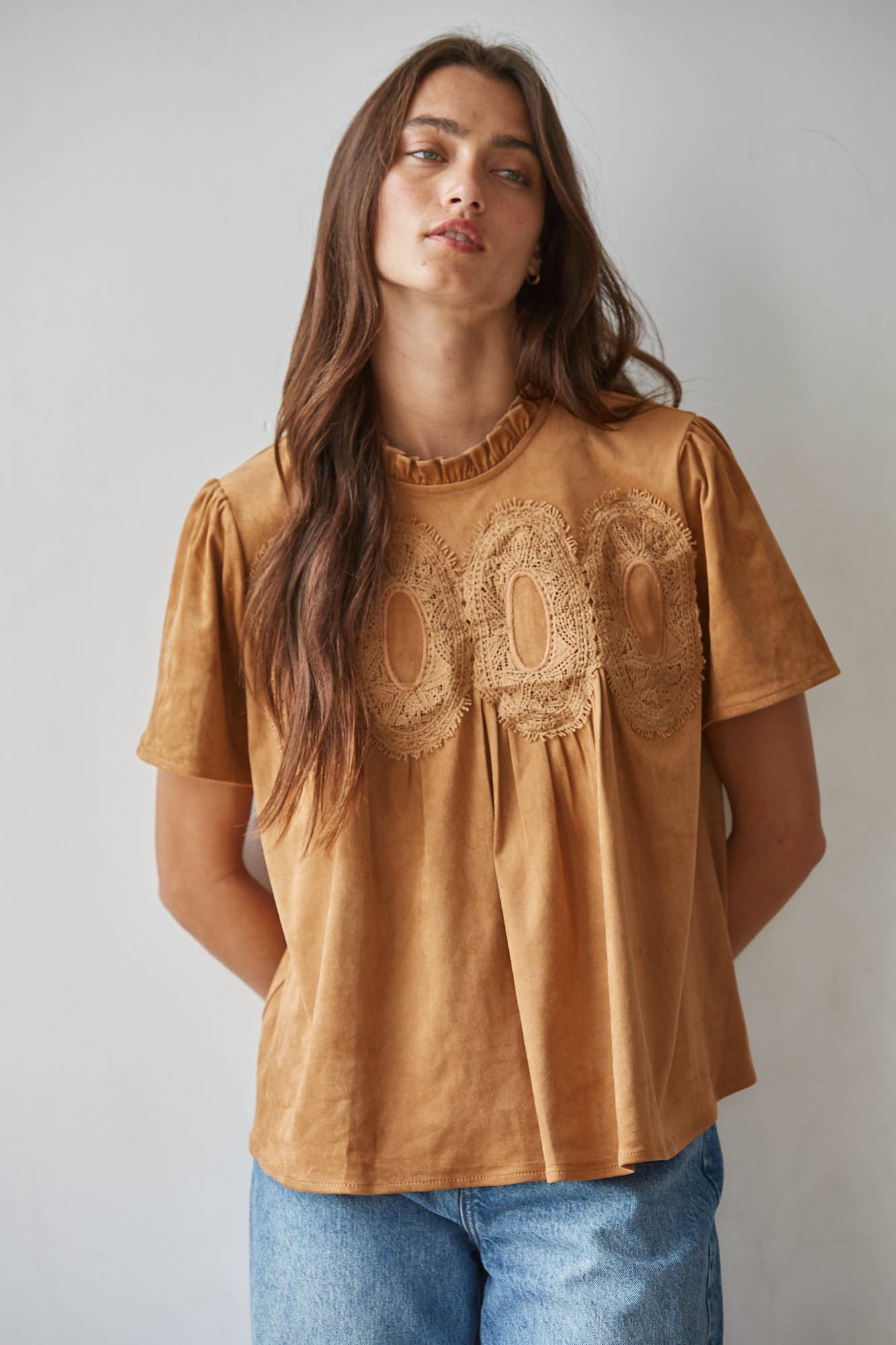 women's butterscotch brown short sleeve top with suede-like finish, ruffle neckline, lace chest detail, and relaxed fit