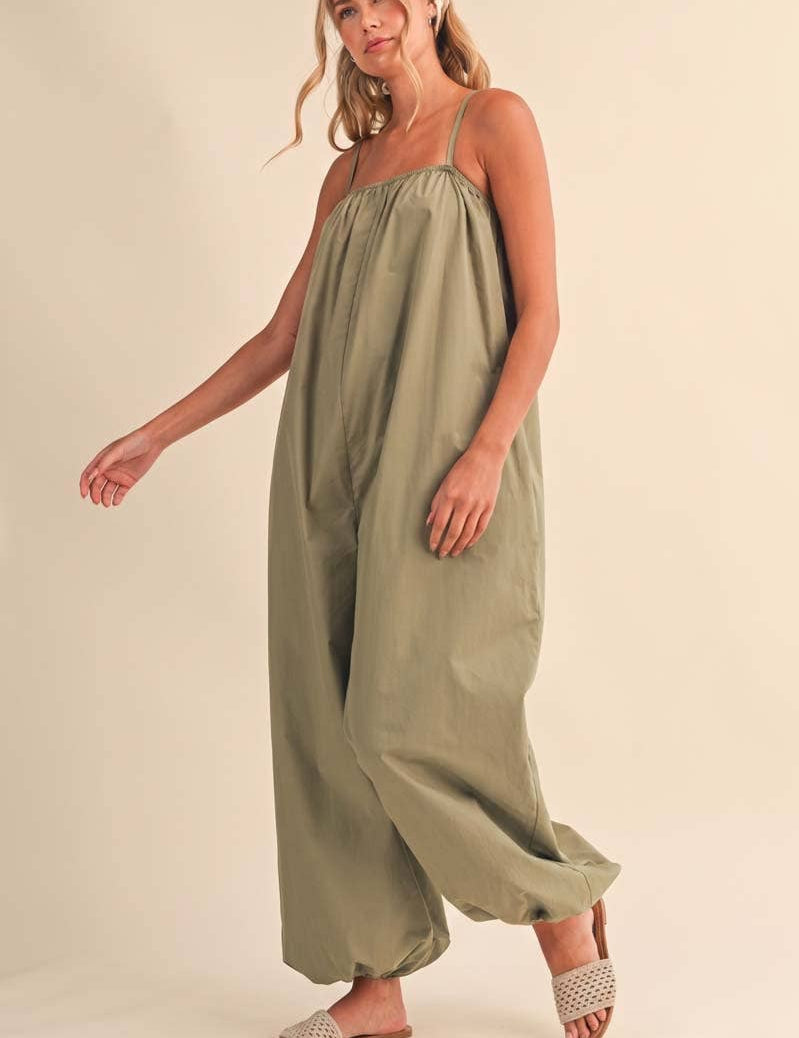 olive green jumpsuit, cotton wide leg jumpsuit, balloon hem jumpsuit, relaxed fit one piece outfit, casual summer jumpsuit, spaghetti strap jumpsuit, oversized cotton jumpsuit, boho green jumpsuit, jumpsuit with pockets, comfortable travel outfit