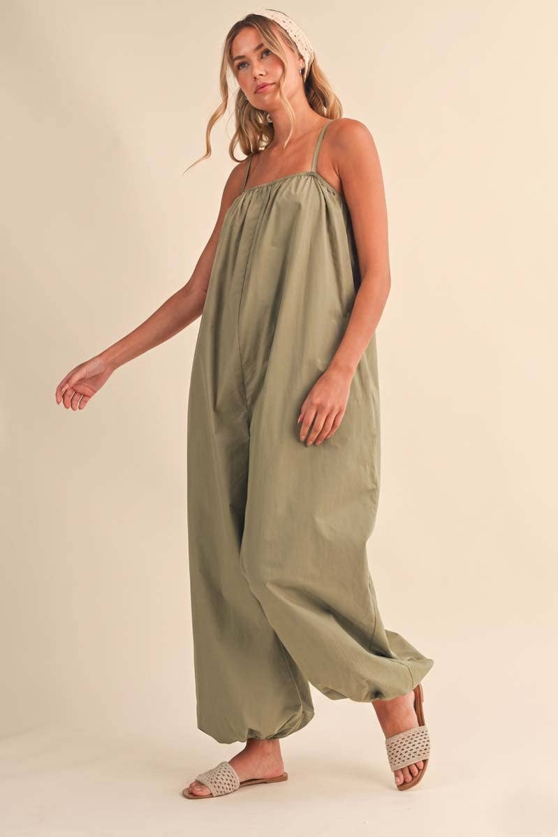 olive green jumpsuit, cotton wide leg jumpsuit, balloon hem jumpsuit, relaxed fit one piece outfit, casual summer jumpsuit, spaghetti strap jumpsuit, oversized cotton jumpsuit, boho green jumpsuit, jumpsuit with pockets, comfortable travel outfit