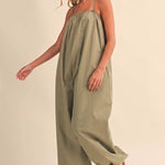 olive green jumpsuit, cotton wide leg jumpsuit, balloon hem jumpsuit, relaxed fit one piece outfit, casual summer jumpsuit, spaghetti strap jumpsuit, oversized cotton jumpsuit, boho green jumpsuit, jumpsuit with pockets, comfortable travel outfit