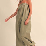 olive green jumpsuit, cotton wide leg jumpsuit, balloon hem jumpsuit, relaxed fit one piece outfit, casual summer jumpsuit, spaghetti strap jumpsuit, oversized cotton jumpsuit, boho green jumpsuit, jumpsuit with pockets, comfortable travel outfit