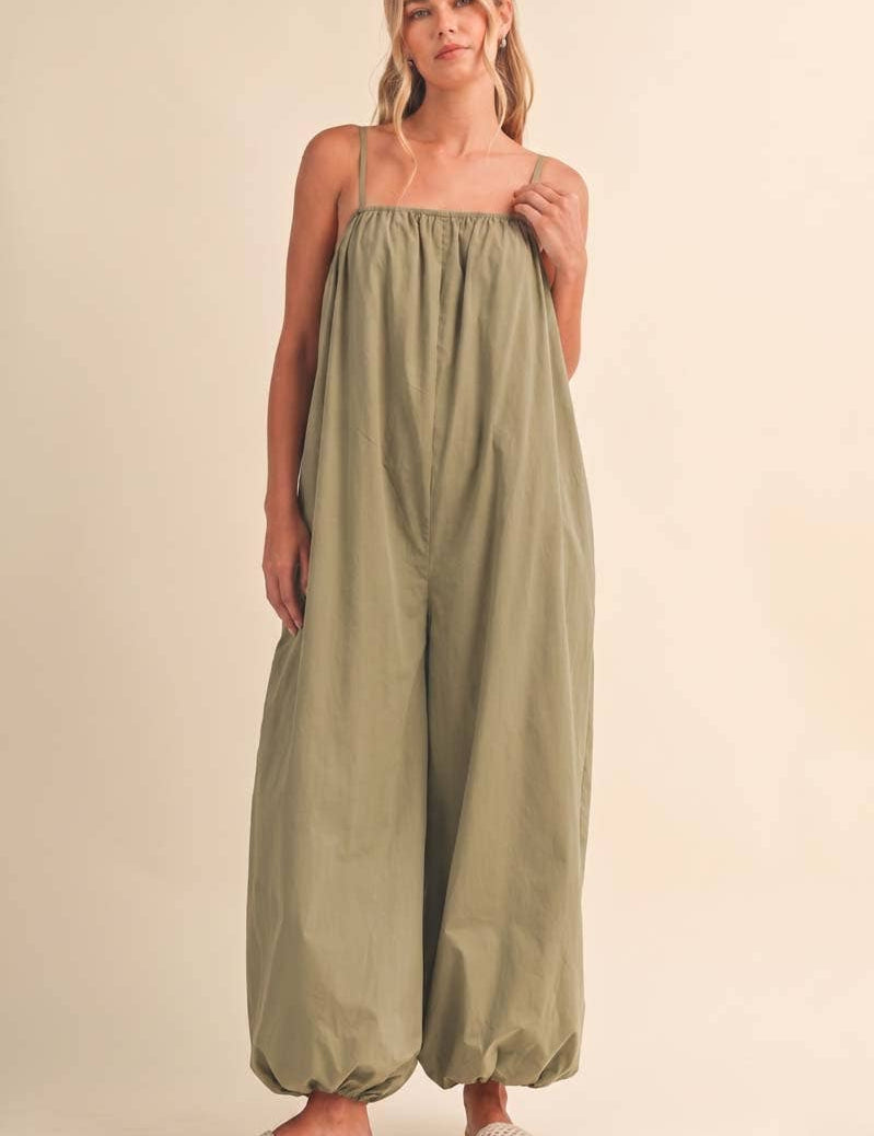 olive green jumpsuit, cotton wide leg jumpsuit, balloon hem jumpsuit, relaxed fit one piece outfit, casual summer jumpsuit, spaghetti strap jumpsuit, oversized cotton jumpsuit, boho green jumpsuit, jumpsuit with pockets, comfortable travel outfit