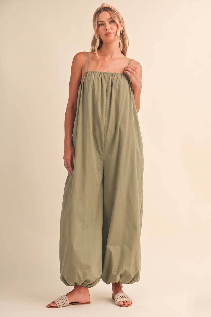 olive green jumpsuit, cotton wide leg jumpsuit, balloon hem jumpsuit, relaxed fit one piece outfit, casual summer jumpsuit, spaghetti strap jumpsuit, oversized cotton jumpsuit, boho green jumpsuit, jumpsuit with pockets, comfortable travel outfit