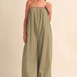 olive green jumpsuit, cotton wide leg jumpsuit, balloon hem jumpsuit, relaxed fit one piece outfit, casual summer jumpsuit, spaghetti strap jumpsuit, oversized cotton jumpsuit, boho green jumpsuit, jumpsuit with pockets, comfortable travel outfit