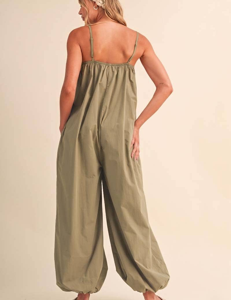 olive green jumpsuit, cotton wide leg jumpsuit, balloon hem jumpsuit, relaxed fit one piece outfit, casual summer jumpsuit, spaghetti strap jumpsuit, oversized cotton jumpsuit, boho green jumpsuit, jumpsuit with pockets, comfortable travel outfit
