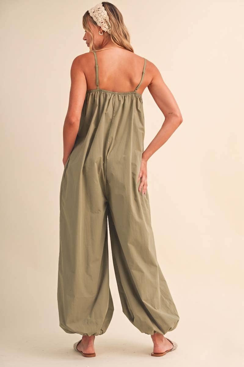 olive green jumpsuit, cotton wide leg jumpsuit, balloon hem jumpsuit, relaxed fit one piece outfit, casual summer jumpsuit, spaghetti strap jumpsuit, oversized cotton jumpsuit, boho green jumpsuit, jumpsuit with pockets, comfortable travel outfit
