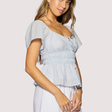 light blue peplum top women
square neck flutter sleeve top
feminine fitted summer blouse
romantic blue going out top
elevated casual boutique top
date night summer top women
european summer style clothing
light blue waist cinching blouse
west of may spritz collection