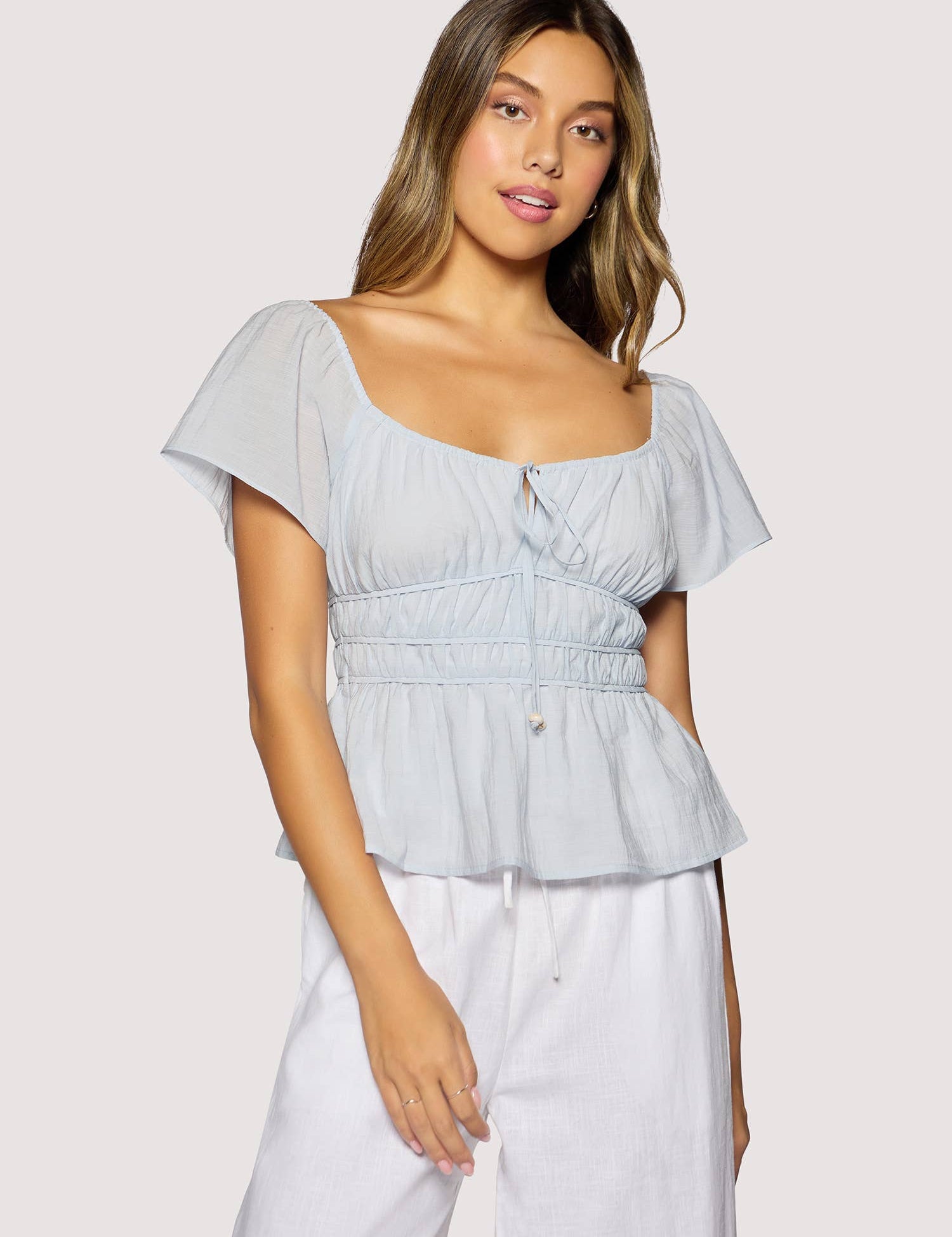 light blue peplum top women
square neck flutter sleeve top
feminine fitted summer blouse
romantic blue going out top
elevated casual boutique top
date night summer top women
european summer style clothing
light blue waist cinching blouse
west of may spritz collection