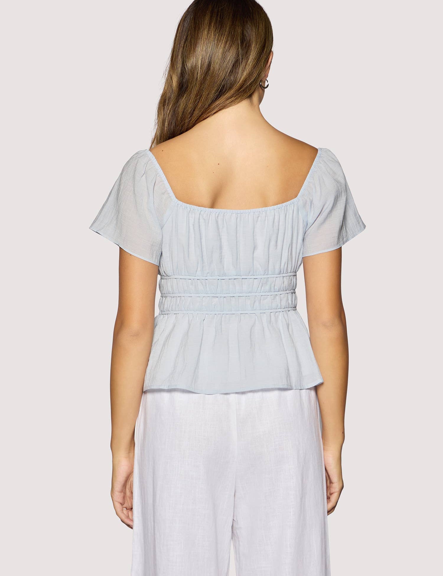 light blue peplum top women
square neck flutter sleeve top
feminine fitted summer blouse
romantic blue going out top
elevated casual boutique top
date night summer top women
european summer style clothing
light blue waist cinching blouse
west of may spritz collection