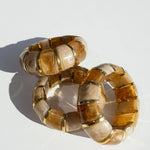 translucent caramel brown resin stretch bracelet with gold accents
