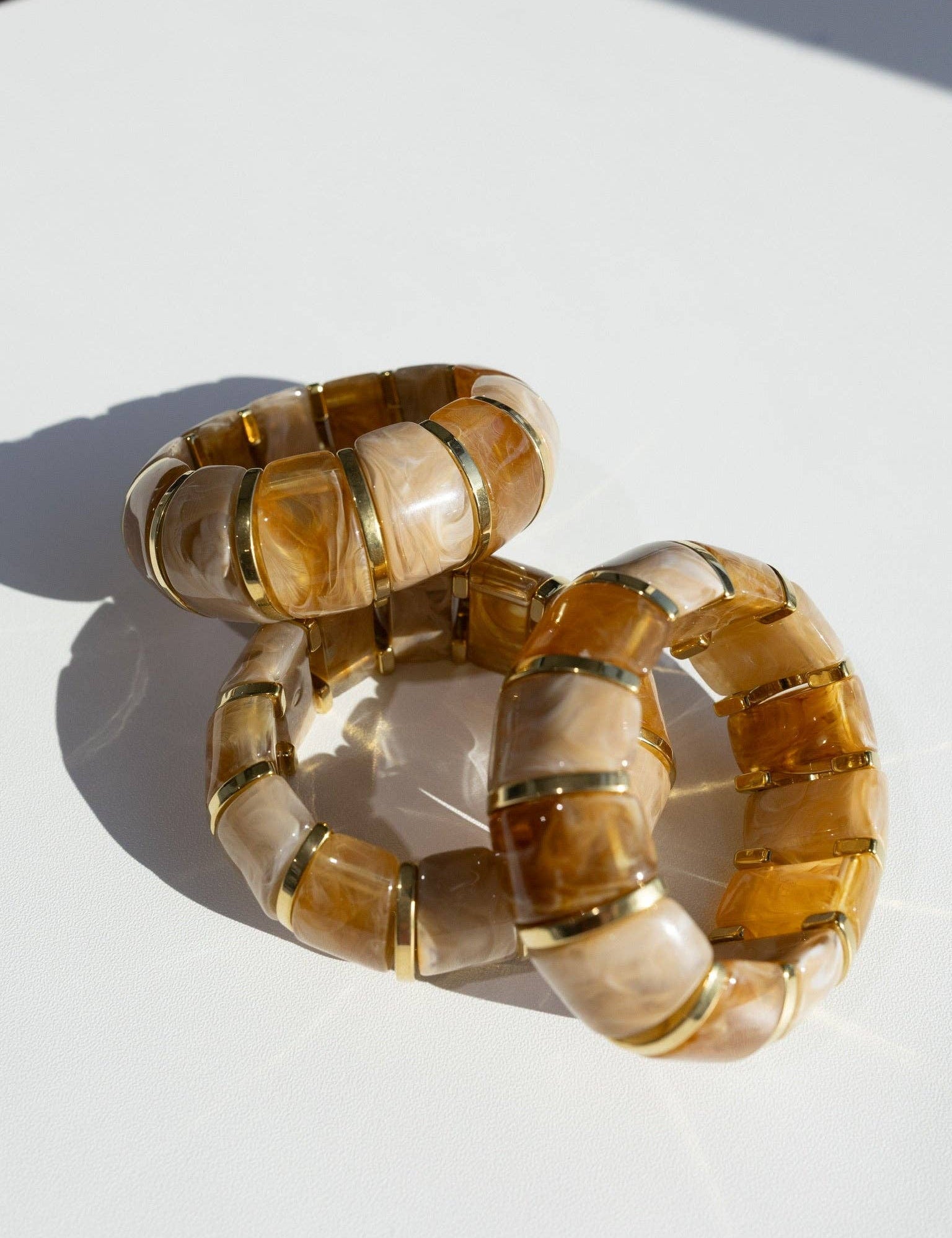 translucent caramel brown resin stretch bracelet with gold accents