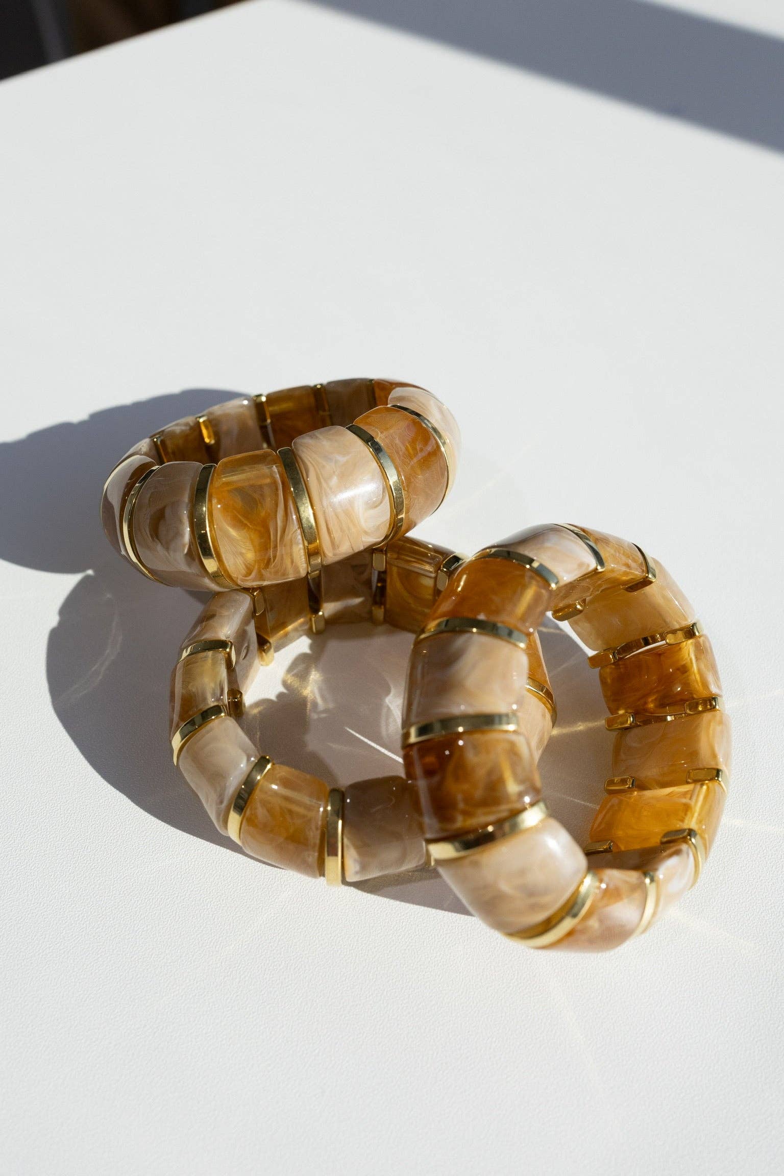 translucent caramel brown resin stretch bracelet with gold accents