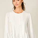 women's white button front blouse with pintuck pleats, long puff sleeves, round neckline, and ruffled babydoll hem