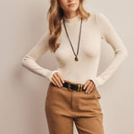 ivory ribbed mock neck top, fitted long sleeve top, stretchy ribbed layering top, women's mock neck shirt, long sleeve top with thumbholes, neutral fall layering top, soft fitted knit top, women's boutique basics