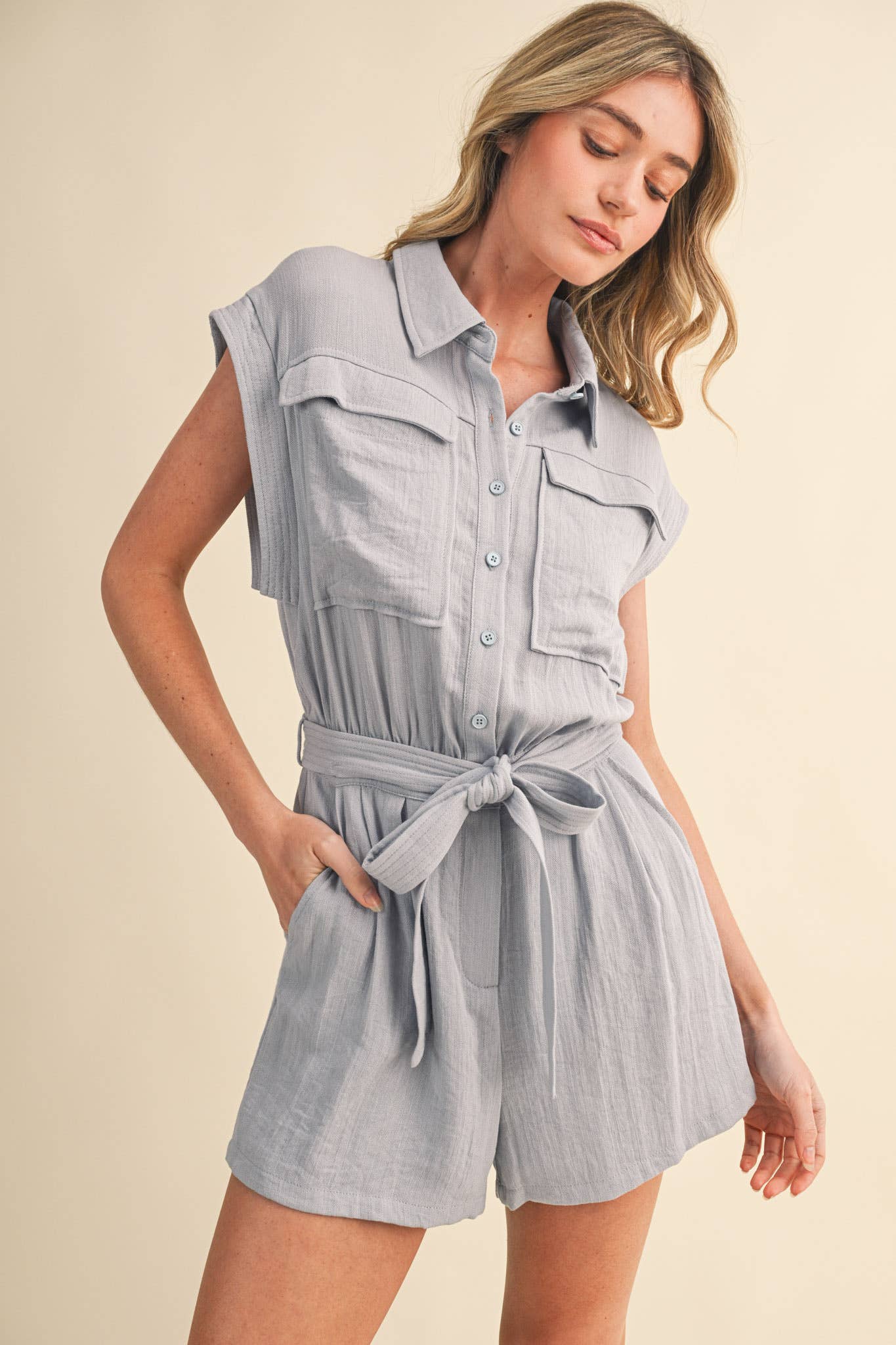 blue utility romper women
collared belted romper
cargo pocket summer romper
lightweight vacation romper
resort wear romper women
casual chic one piece outfit
travel outfit romper women
blue sleeveless romper boutique
elevated utility romper
west of may spritz collection