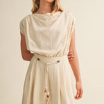 ream wide leg jumpsuit, cowl neck jumpsuit, linen blend jumpsuit, neutral one piece outfit, drawstring waist jumpsuit, resort wear jumpsuit, cap sleeve jumpsuit, flowy wide leg romper, elegant casual jumpsuit, women's cream jumpsuit