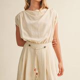 ream wide leg jumpsuit, cowl neck jumpsuit, linen blend jumpsuit, neutral one piece outfit, drawstring waist jumpsuit, resort wear jumpsuit, cap sleeve jumpsuit, flowy wide leg romper, elegant casual jumpsuit, women's cream jumpsuit