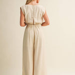 ream wide leg jumpsuit, cowl neck jumpsuit, linen blend jumpsuit, neutral one piece outfit, drawstring waist jumpsuit, resort wear jumpsuit, cap sleeve jumpsuit, flowy wide leg romper, elegant casual jumpsuit, women's cream jumpsuit
