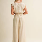 ream wide leg jumpsuit, cowl neck jumpsuit, linen blend jumpsuit, neutral one piece outfit, drawstring waist jumpsuit, resort wear jumpsuit, cap sleeve jumpsuit, flowy wide leg romper, elegant casual jumpsuit, women's cream jumpsuit