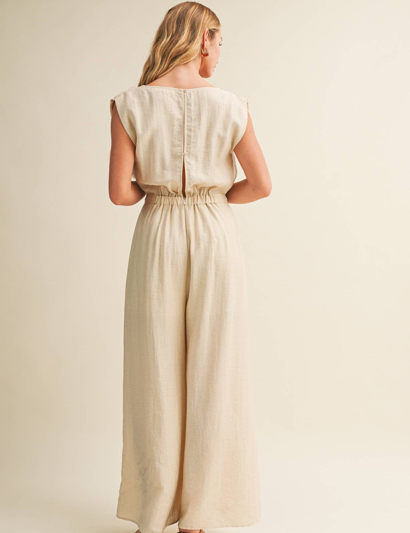 ream wide leg jumpsuit, cowl neck jumpsuit, linen blend jumpsuit, neutral one piece outfit, drawstring waist jumpsuit, resort wear jumpsuit, cap sleeve jumpsuit, flowy wide leg romper, elegant casual jumpsuit, women's cream jumpsuit